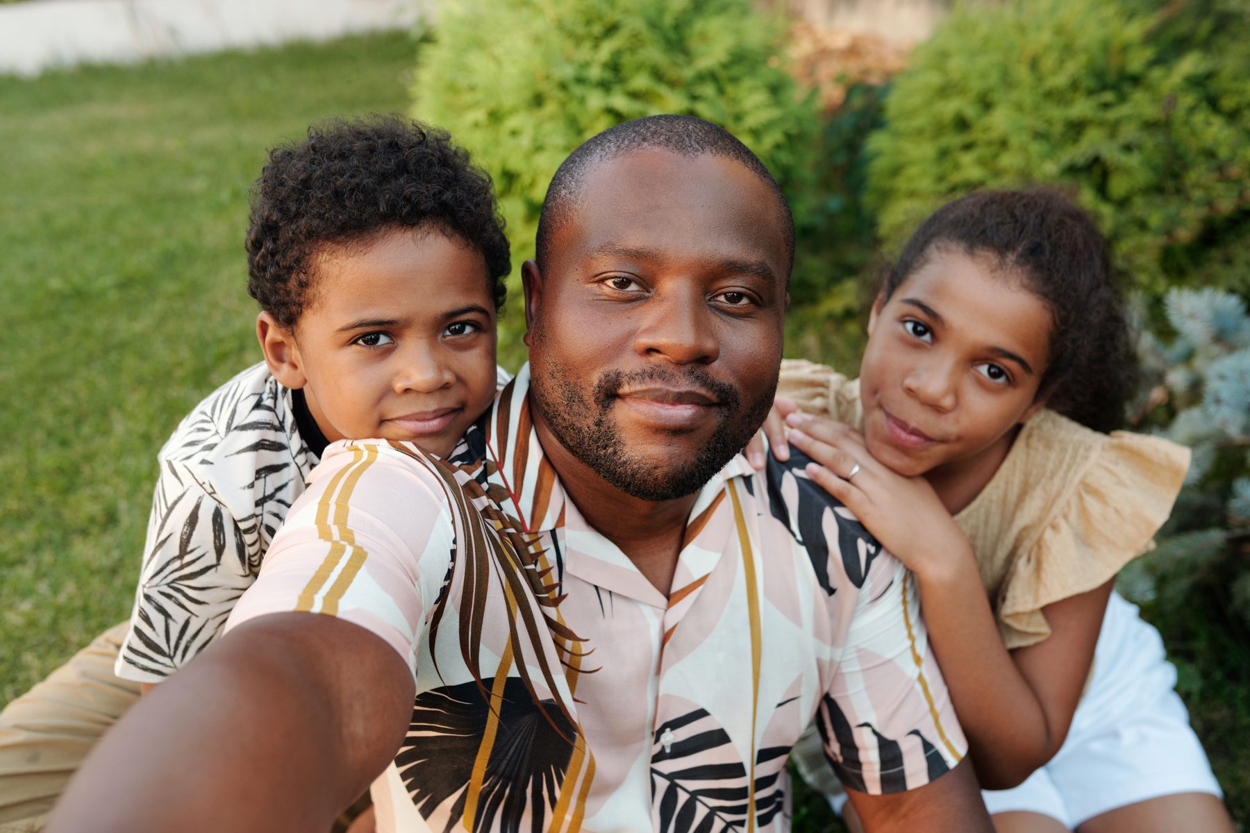 A Nigerian family smiling outdoors